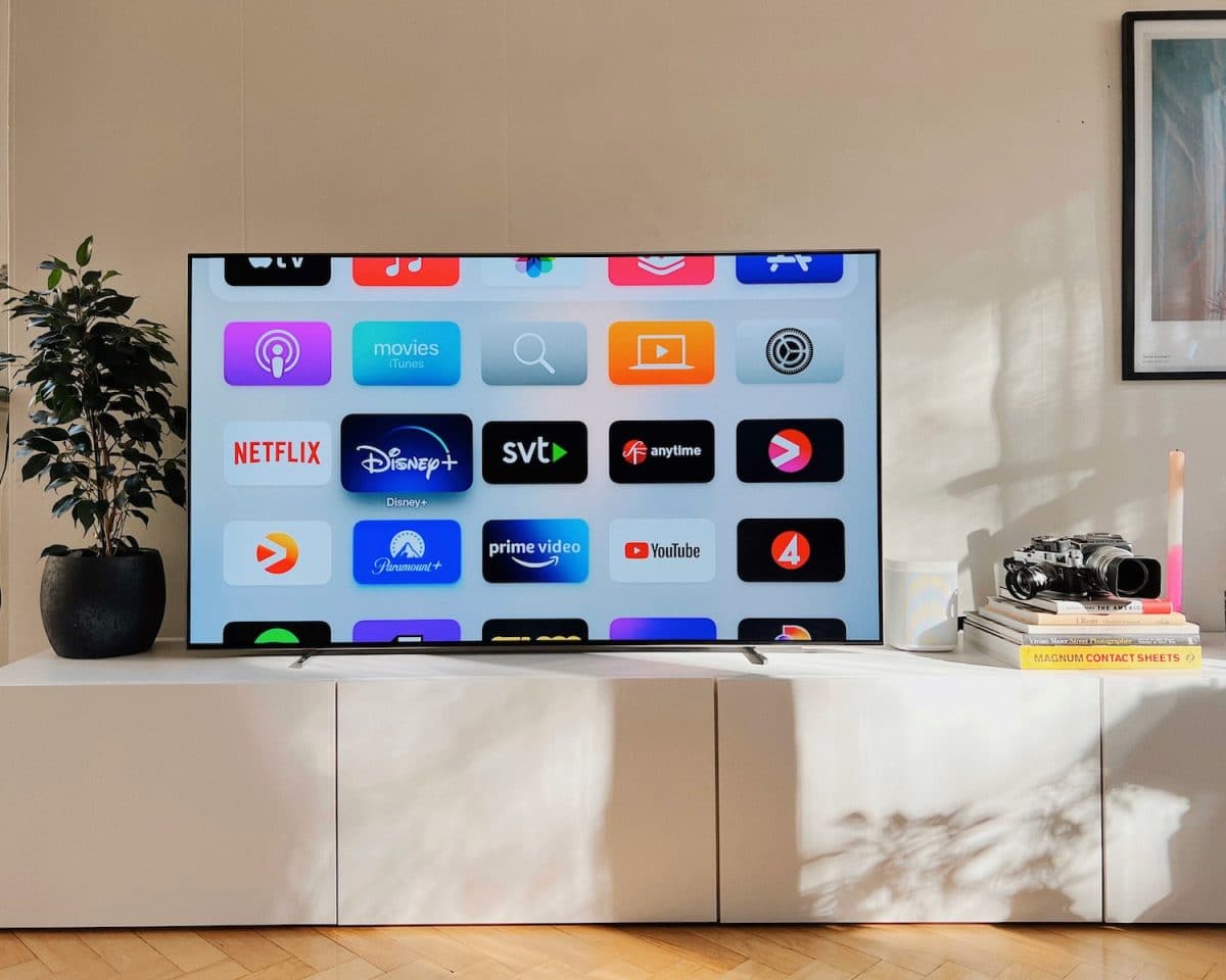 a flat screen tv sitting on top of a white cabinet